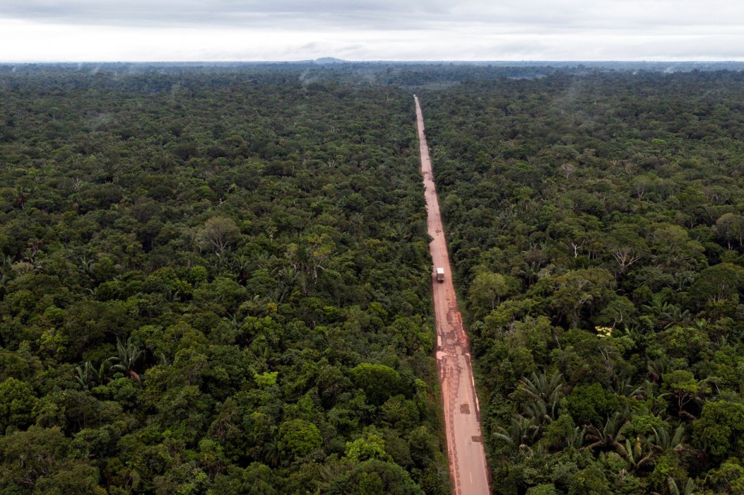 Aerial photo showing a highway cutting through the Amazon rainforest.