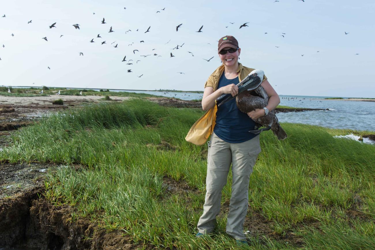 Autumn-Lynn Harrison with a brown pelican