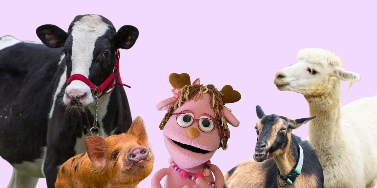 A pink jackalope puppet stands in the center surrounded by a black and white cow and a reddish-brown pig on their left. On their right is a white alpaca and a brown and black goat.