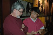 Scientist Dr. Dave Wildt (left) speaks with Dr. Li Desheng (right) inside the giant panda house at the Smithsonian's National Zoo