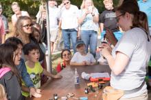 Students watch a bird-banding demonstration by Smithsonian Migratory Bird Center scientists at Conservation Discovery Day. A bird-banding demonstration by Smithsonian Migratory Bird Center Scientists at Conservation Discovery Day.