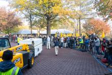A forklift carries a crate holding giant panda Bei Bei past a line of media at the Smithsonian's National Zoo. A yellow fork lift carries a crate holding giant panda Bei Bei past a line of videographers and photographers
