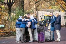 Giant panda Bei Bei's keepers embrace after Bei Bei's departure from the Zoo. a group of panda keepers embrace in one huge hug