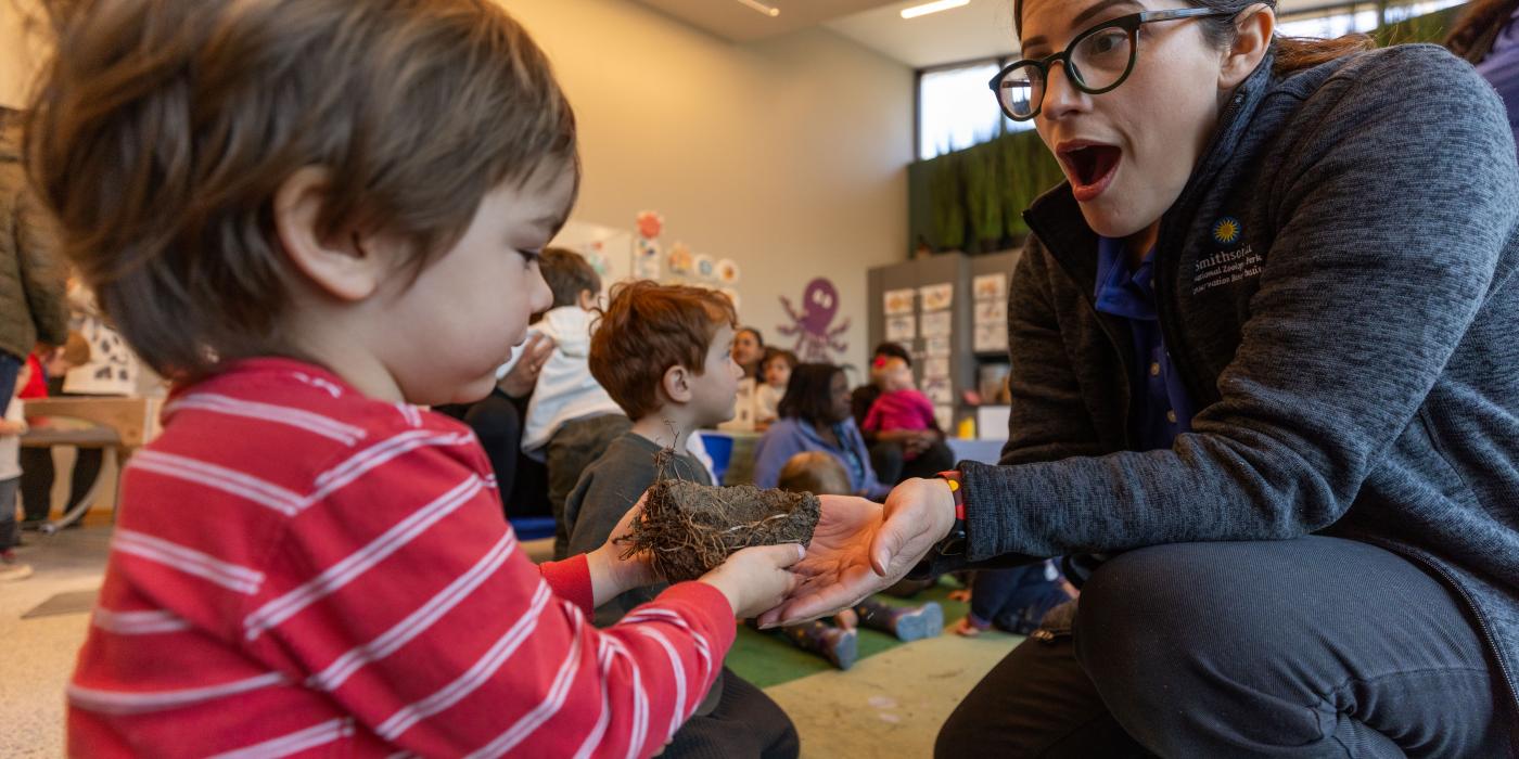 Educator explores a bird nest with young child