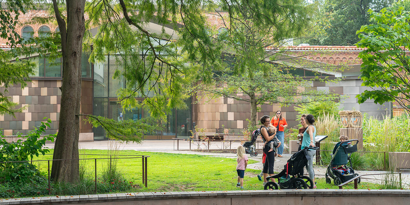 Visitors hang out on the grassy lawn near the Bird House.
