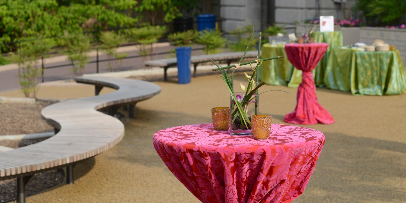 Cocktail tables decorated in brightly colored table cloths outside the Zoo's Elephant Community Center